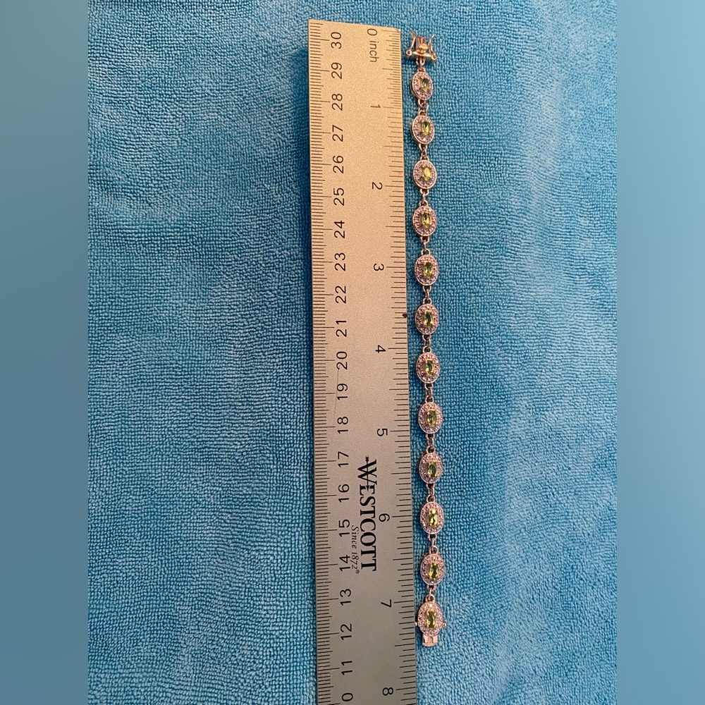 Gold over sterling silver light blue stone bracelet surrounded by CZ